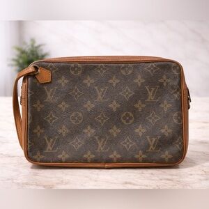 Vintage Louis Vuitton 1980's Monogram clutch-style. Horizontal exterior zipper.